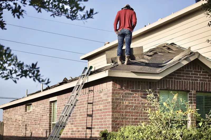 Professional roofer working on a residential roof in Branford